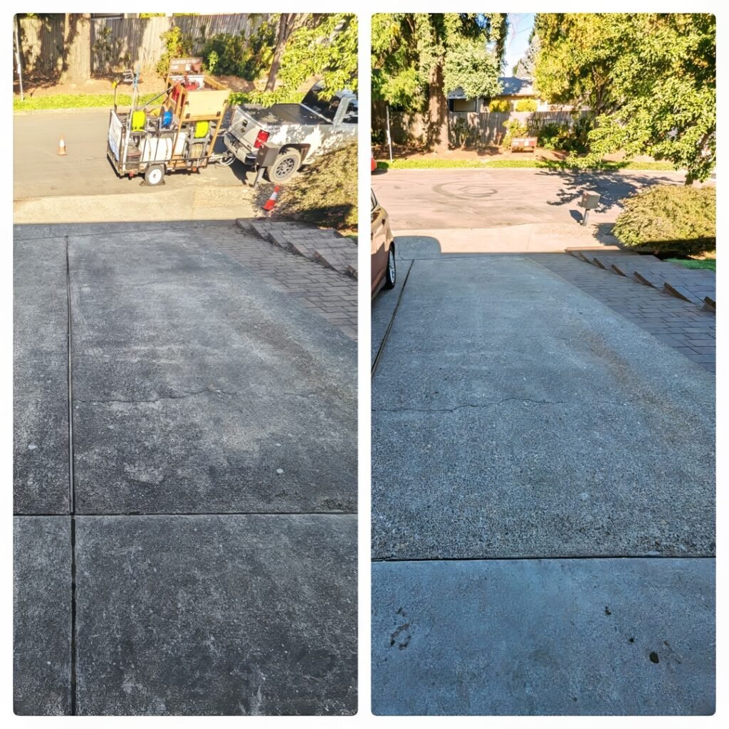 Before and after images of a concrete driveway pressure washing service in Tualatin, OR. The left image shows the driveway with dark stains and a layer of dirt. The right image presents the same driveway looking significantly cleaner and lighter in color following the pressure washing, with visible improvement in its overall cleanliness and appearance. The surrounding area with trees and a parked trailer in the before image and a clear driveway in the after image demonstrates the effectiveness of the service.